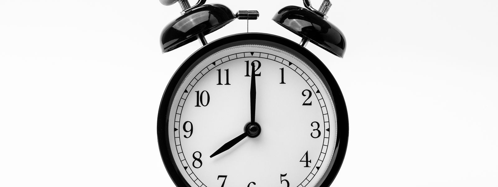 Black twin-bell alarm clock against a plain white background